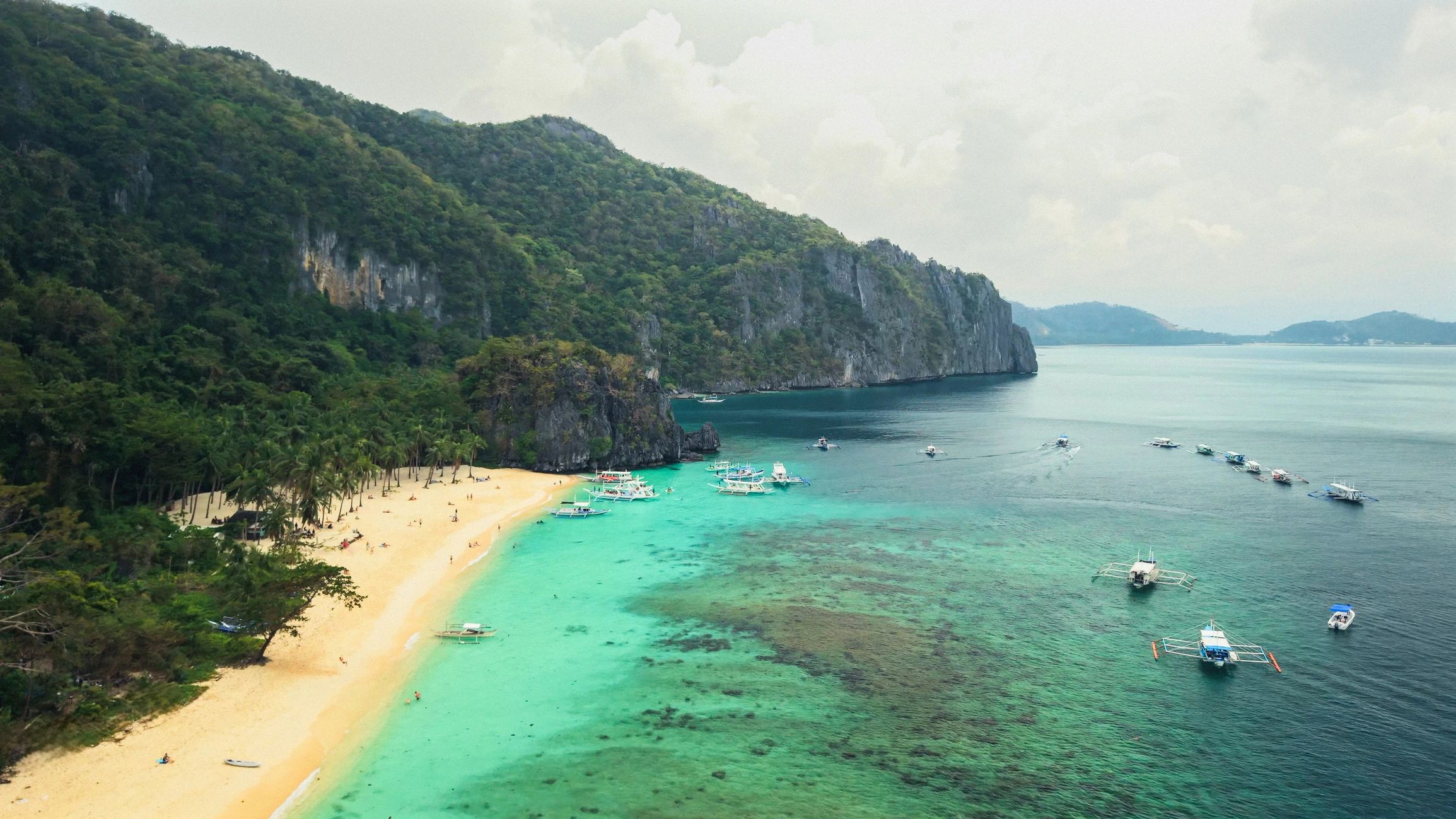 Tropical white-sand beach and turquoise water in the Philippines